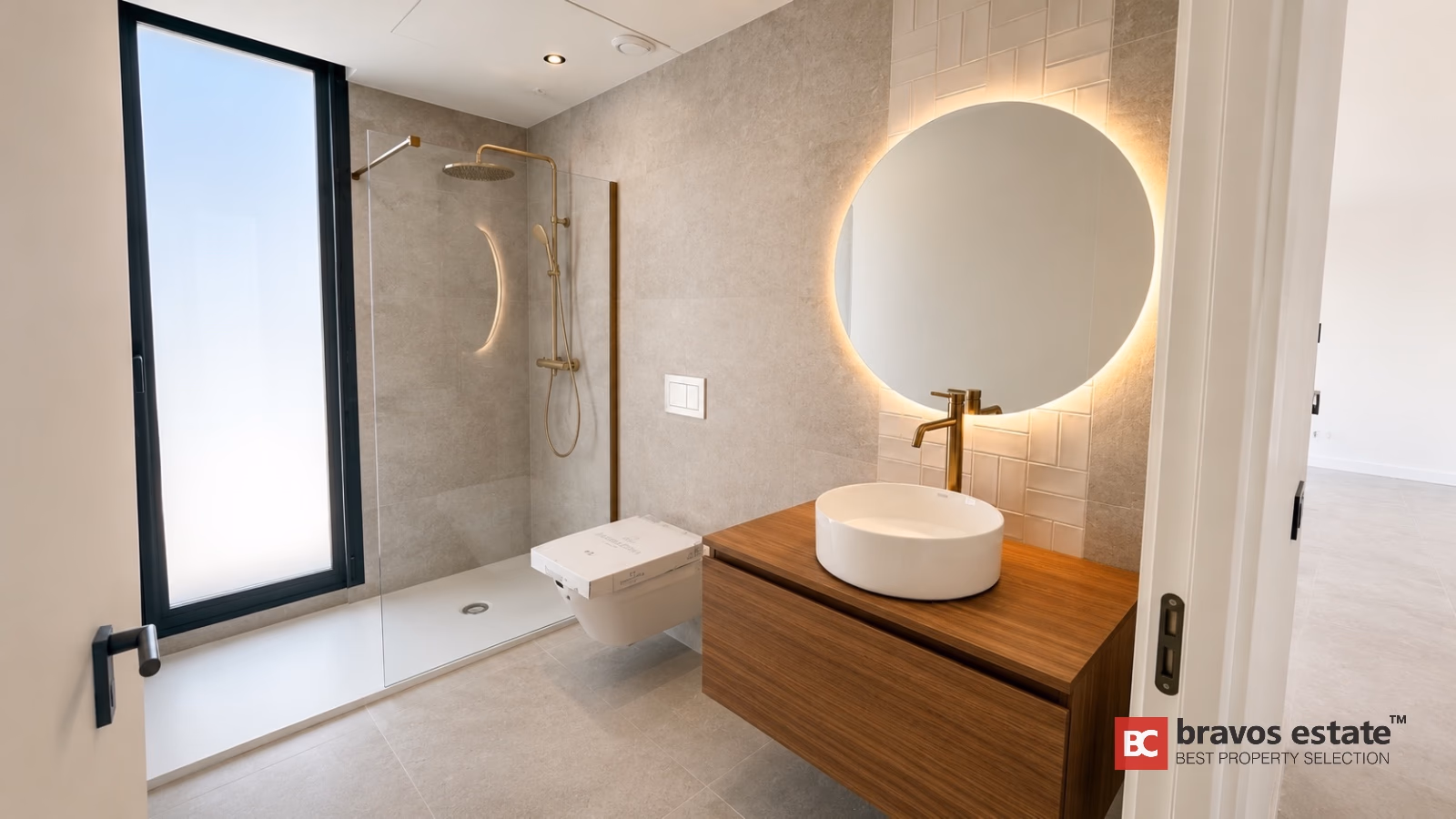 Modern bathroom with gold fixtures and backlit mirror in Finestrat villa