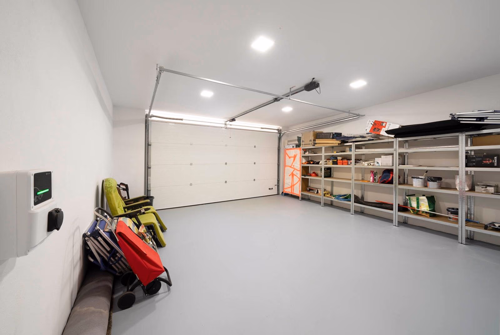 Two-car private garage with EV charger and storage shelving