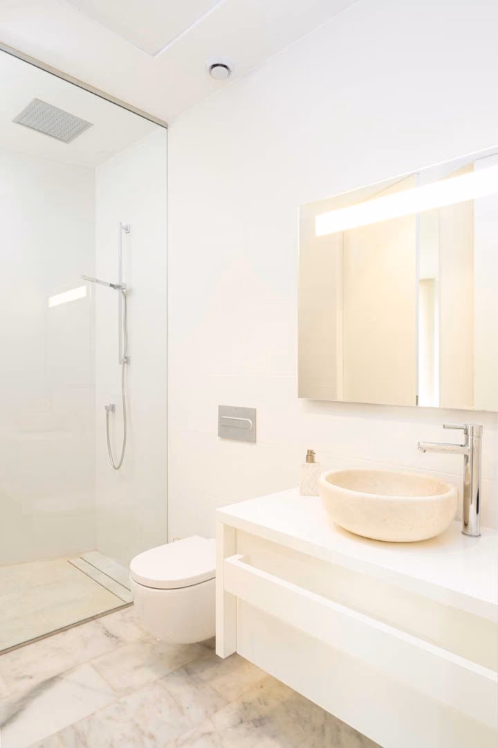Bathroom with walk-in shower and marble flooring