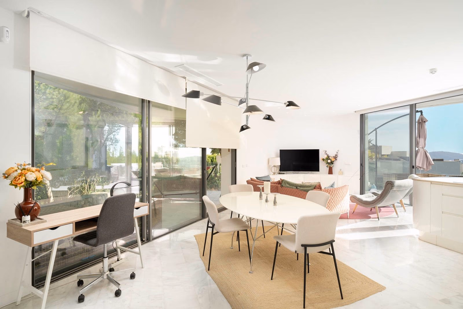 Living-dining room with TV wall and full-height sliding doors