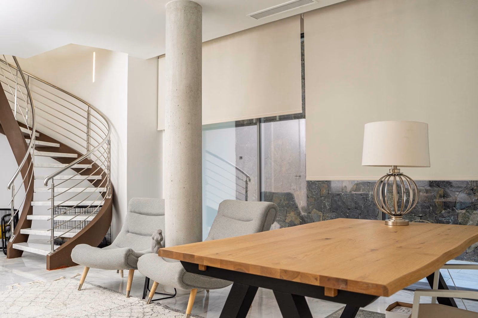 Basement dining area with concrete pillar and natural stone backdrop