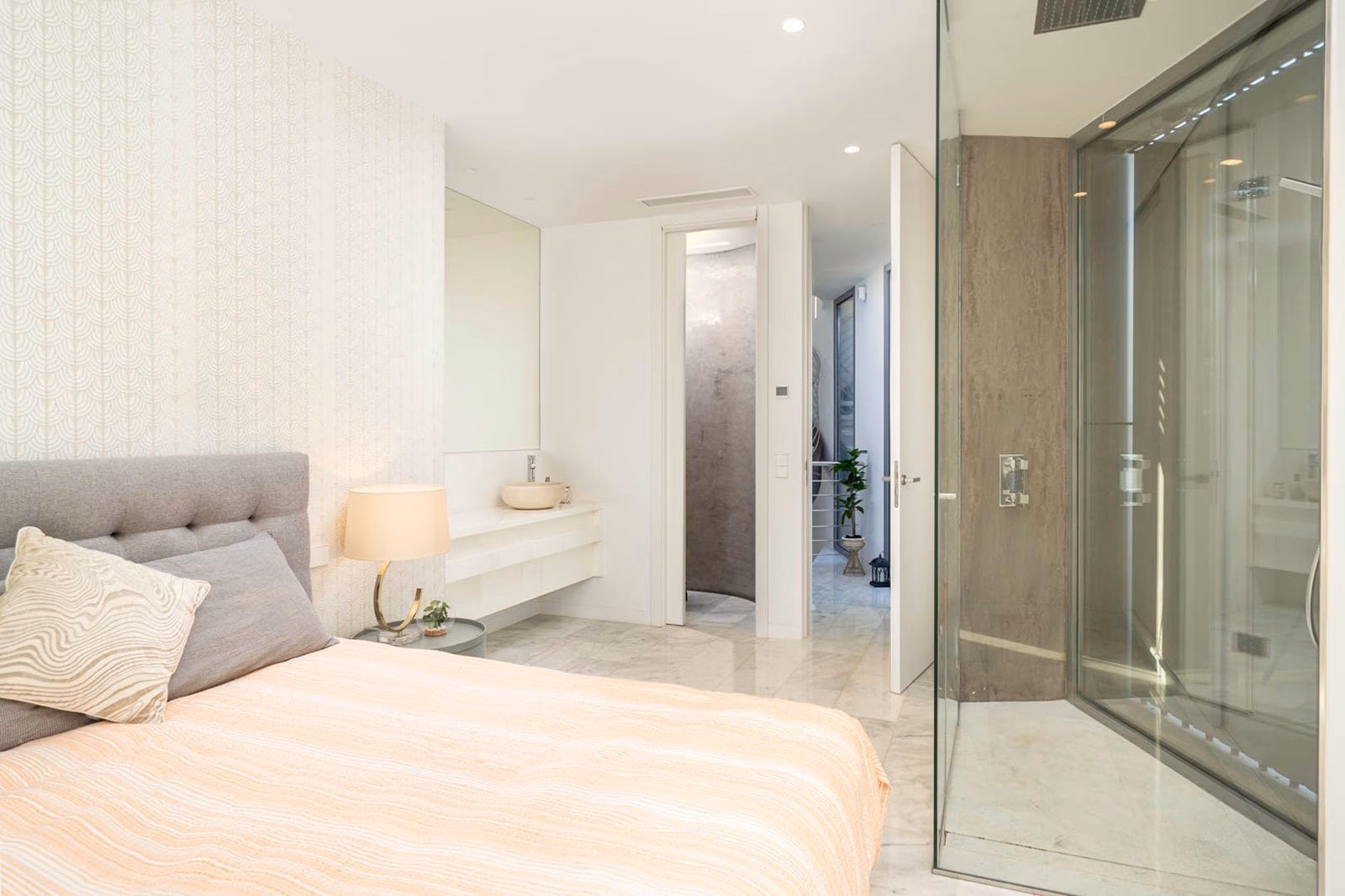 Bedroom with microcement walls and walk-through shower