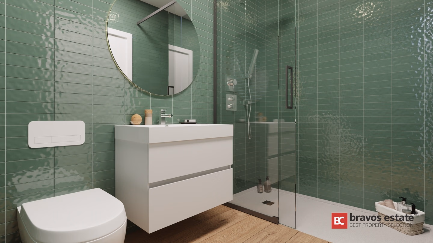 CGI-рендер ванной комнаты в Bonalba Green Villas с глянцевой зелёной плиткой, подвесным унитазом, белой тумбой с раковиной, круглым зеркалом и стеклянной душевой кабиной.