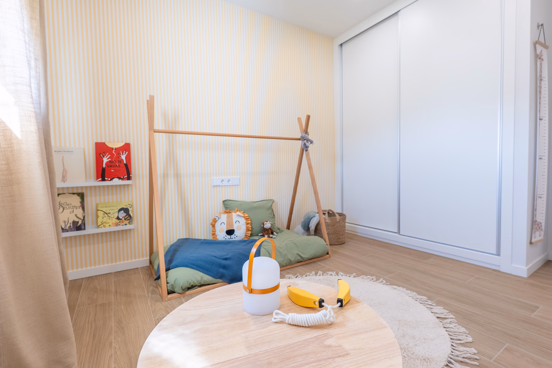 Children's bedroom with play tent and striped wallpaper