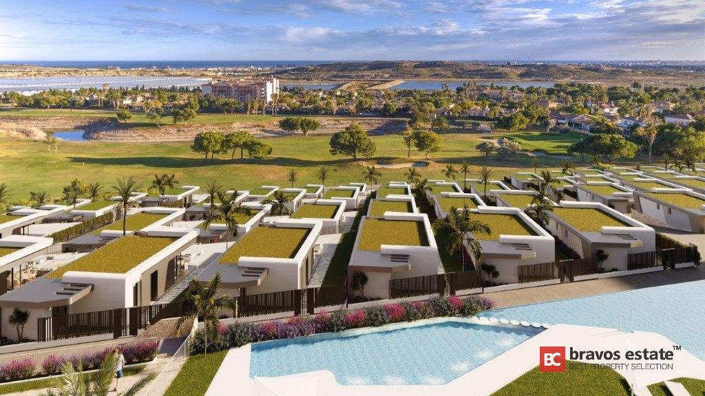 CGI-визуализация Bonalba Green Villas: вид с высоты птичьего полёта на белые современные виллы с озеленёнными крышами, общий бассейн и поле для гольфа курорта Bonalba, уходящее к побережью.